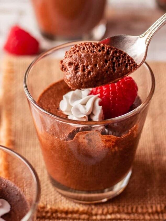 easy vegan raspberry panna cotta without gelatin, 3 ingredient dairy free chocolate mousse in a clear glass with a spoon it it
