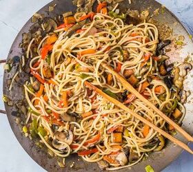 vegan stir fry noodles ready in under 30 minutes, Stirring the noodles and the sauce in a wok