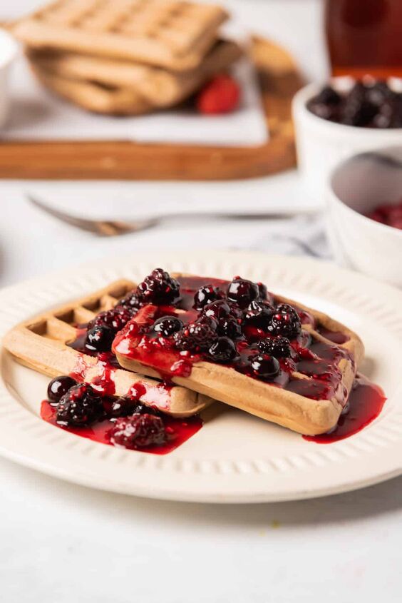 best vegan waffles easy homemade recipe, Vegan waffles topped with berry syrup on a white plate