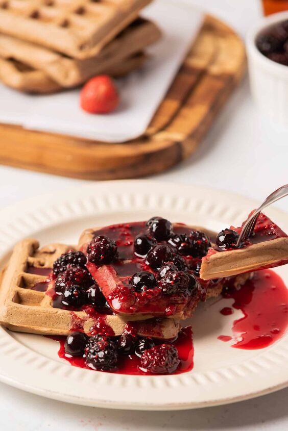 best vegan waffles easy homemade recipe, Tasting vegan waffles topped with fruit syrup on a white plate