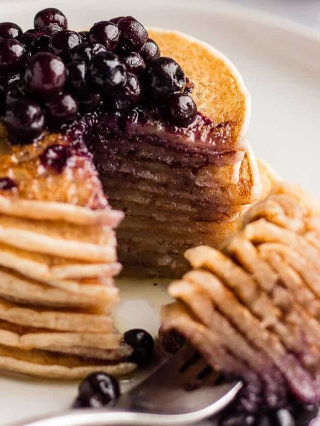 best vegan waffles easy homemade recipe, A stack of Cassava flour pancakes on a white plate served with blueberries on top