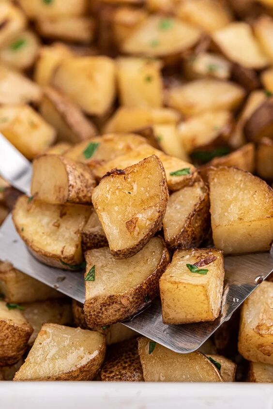 easy roasted potatoes made with one magic packet, Easy roasted potatoes spatula scooping roasted potatoes up out of a big dish of them