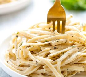 creamy white wine pasta sauce, A plate of pasta with creamy white wine sauce on a pale blue background