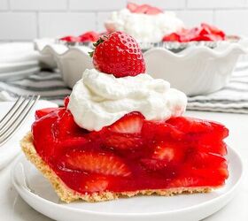 no bake strawberry pie with jello, side view of piece of strawberry pie topped with whipped cream and a strawberry