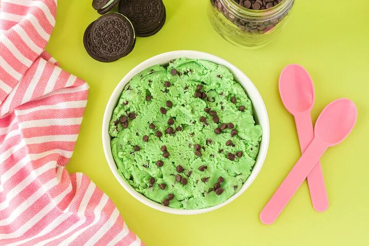 mint chip edible cookie dough, Overhead image of mint cookie dough with chips and pink spoons on a green table