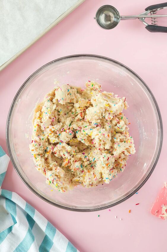 soft and chewy funfetti cookies recipe, Sprinkles mixed in cookie dough in a bowl
