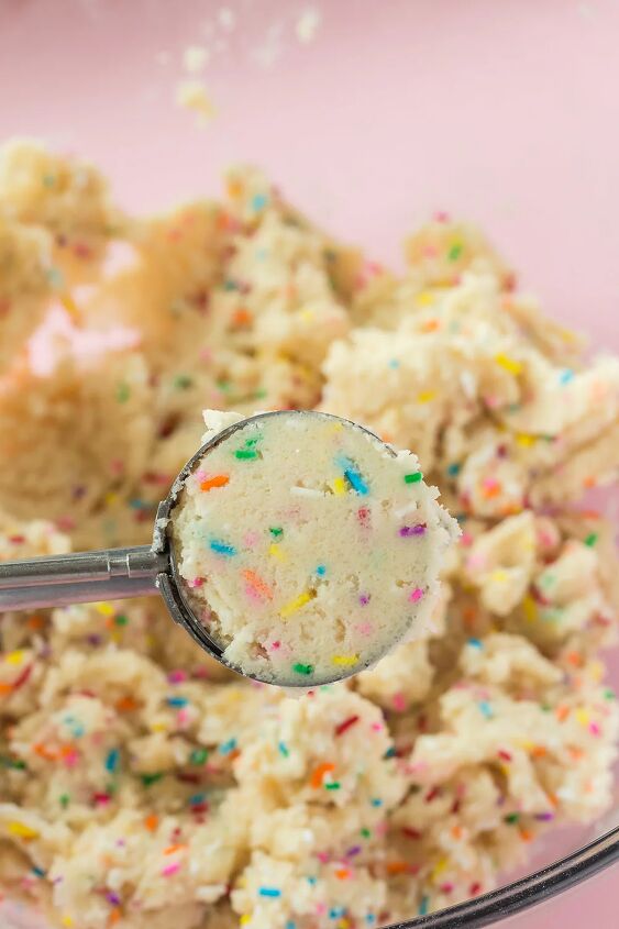 soft and chewy funfetti cookies recipe, Scoop of cookie dough above the batter