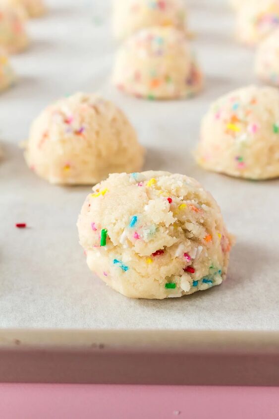 soft and chewy funfetti cookies recipe, Sprinkles on top of cookie dough balls on a sheet