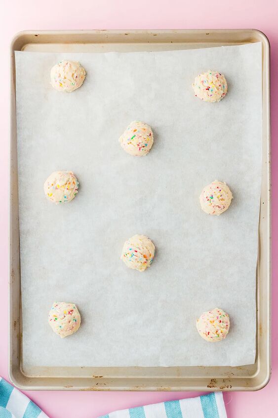 soft and chewy funfetti cookies recipe, Cookie dough balls on a baking sheet with parchment paper