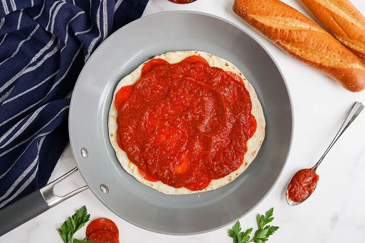 skillet pepperoni pizza quesadillas recipe, Sauce on top of a tortilla in a skillet
