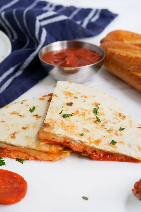 skillet pepperoni pizza quesadillas recipe, Two quesadilla slices on a table with dipping sauce