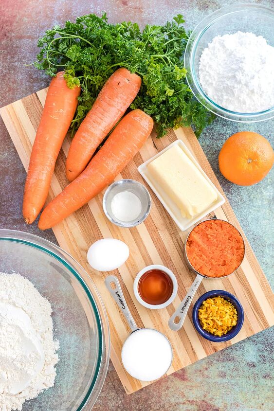 unique carrot cookies with orange juice glaze, Carrots sugar flour and other ingredients on a board