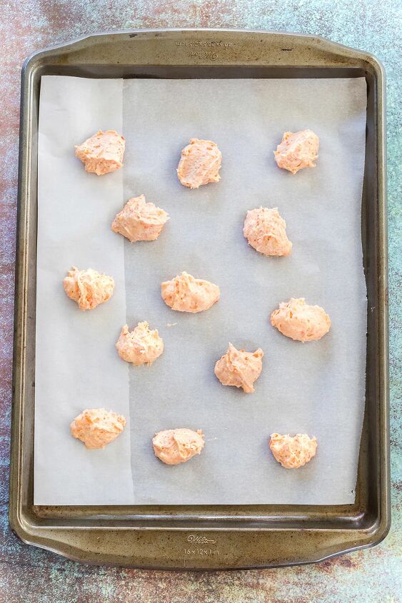 unique carrot cookies with orange juice glaze, Drops of cookie dough on a baking sheet