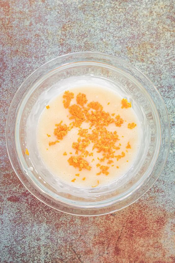 unique carrot cookies with orange juice glaze, Carrot shavings in a bowl with glaze