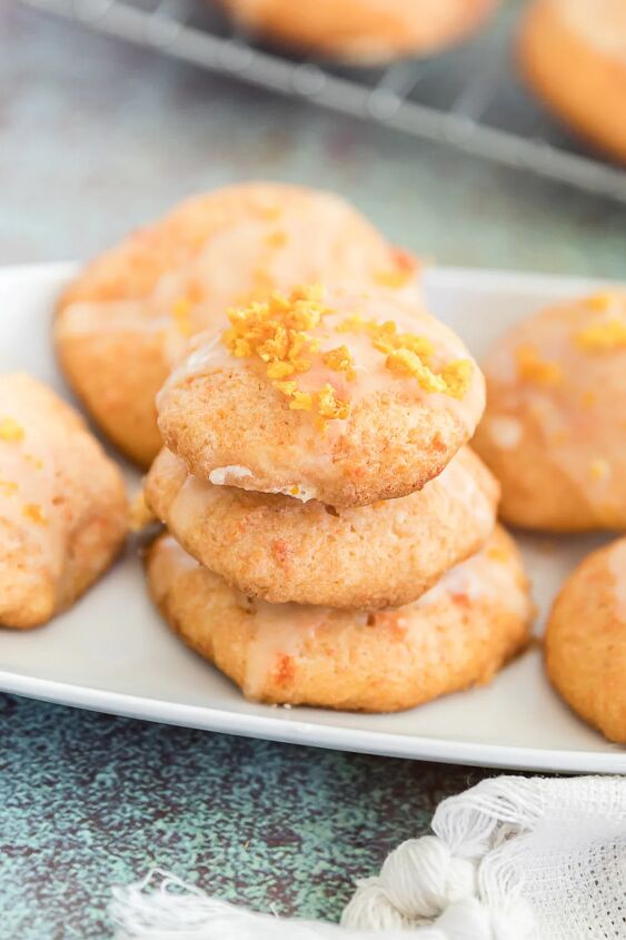 unique carrot cookies with orange juice glaze, Stacked cookies on a tray The cookies have a carrot glaze and are orange in color