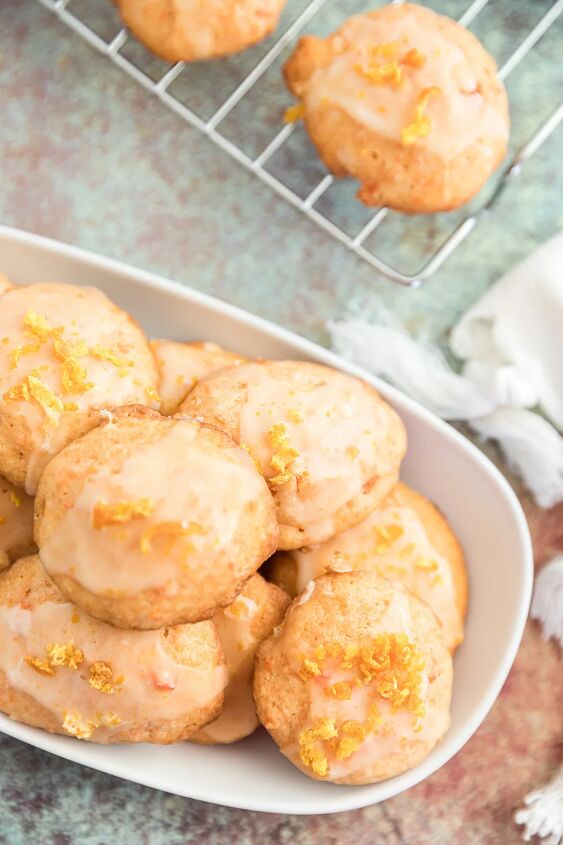 unique carrot cookies with orange juice glaze, Overhead shot of carrot orange cookies on a rack and on a tray