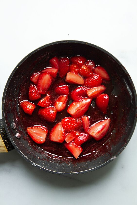 strawberries and cream, A frying pan containing the strawberrries which are being heated until softened