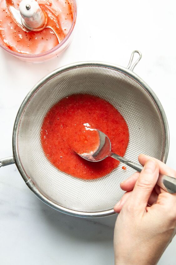 strawberries and cream, The blended mixture of strawberries icing sugar and lemon juice being strained through a sieve