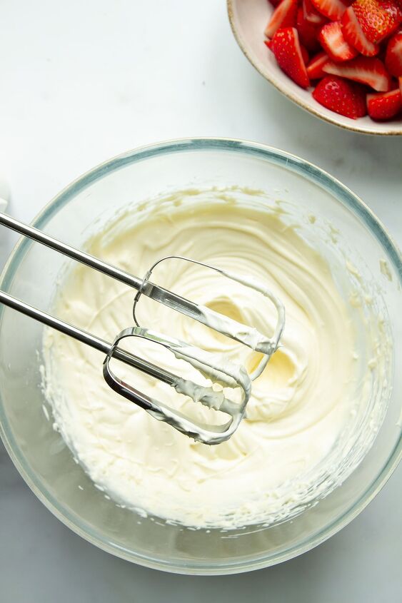 strawberries and cream, A bowl of cream icing sugar and vanilla essence being whisked until stiff peaks start to form
