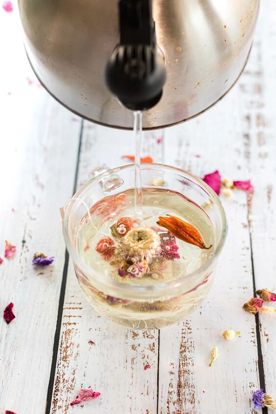diy floral tea globes for blooming flower tea, Pouring hot water over a flower tea drop in a mug
