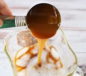 copycat caramel crunch frappuccino recipe, Pouring caramel into a blender with ice and coffee