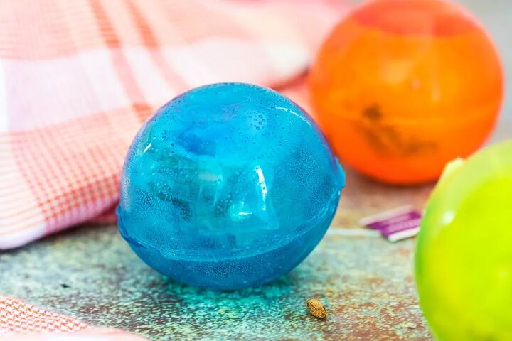 homemade hot tea drops recipe, Hot tea bomb in blue and orange sitting on a counter