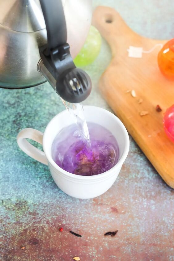 homemade hot tea drops recipe, Pouring water into a mug with a bag of tea