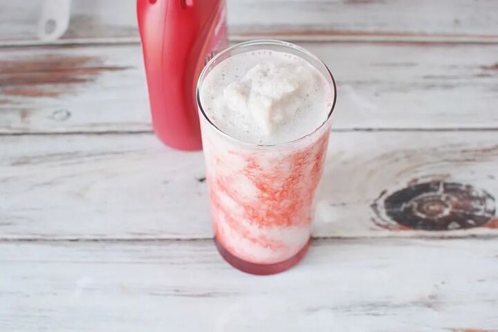 delicious copycat strawberry frappuccino recipe, Strawberry syrup next to a glass of a pink blended drink