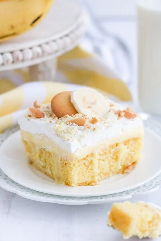light and creamy banana poke cake recipe, Banana pudding cake topped with whipped cream and cookies