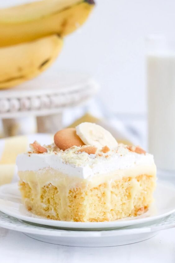 light and creamy banana poke cake recipe, Yellow cake on a white plate with bananas and cookies