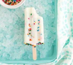 happy funfetti cake batter popsicles, Bite taken out of a cake mix popsicle on ice