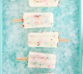 happy funfetti cake batter popsicles, Cake batter pops in a row sitting on ice on a blue tray