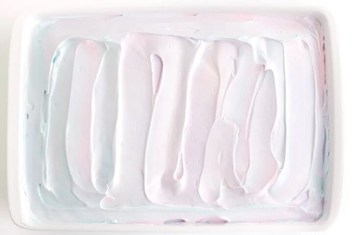 rainbow unicorn poke cake recipe, White frosting on a cake