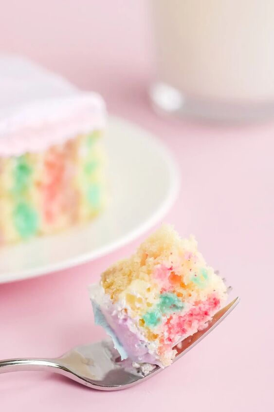 rainbow unicorn poke cake recipe, Fork with cake on it with a slice of poke cake on a plate
