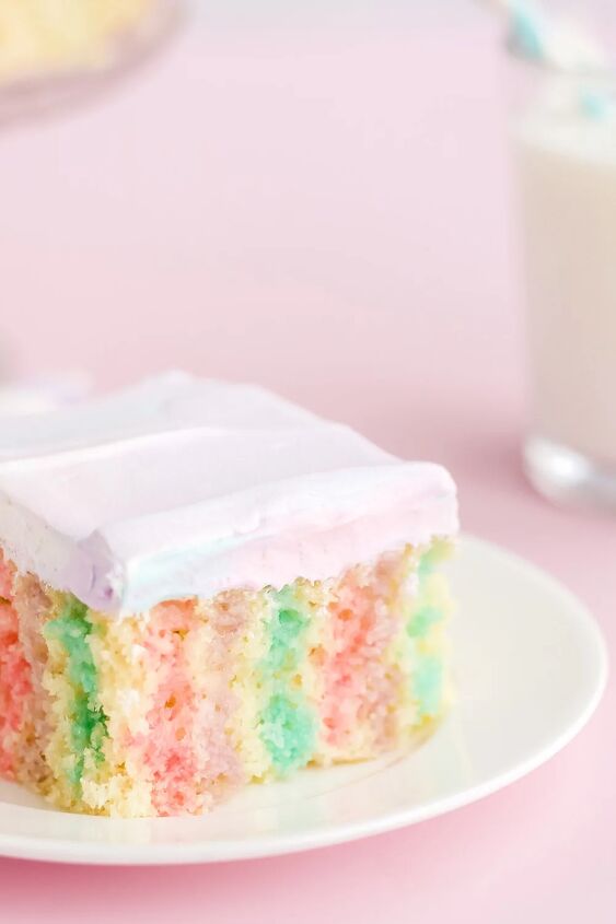 rainbow unicorn poke cake recipe, Unicorn poke cake on a white plate