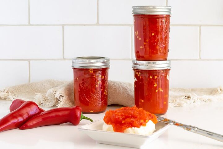 red pepper jelly, jars of red pepper jelly and red pepper jelly over cream cheese