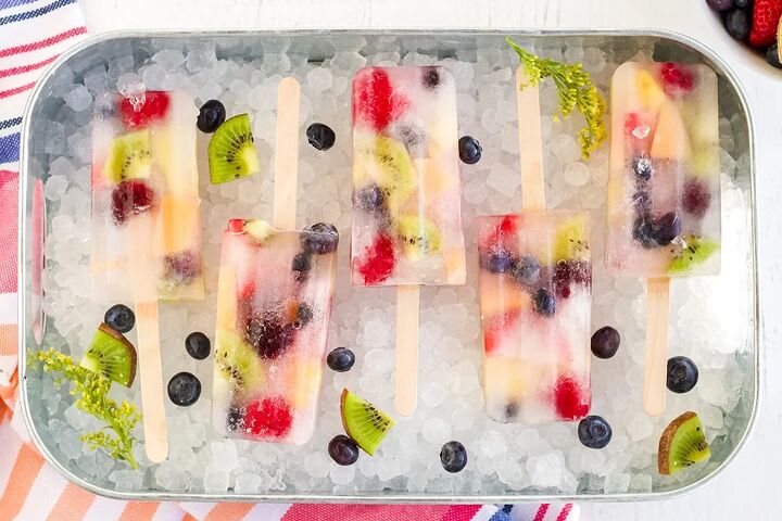 rainbow fruit popsicles, Rainbow fruit popsicles lined up in a try with nugget ice cubes