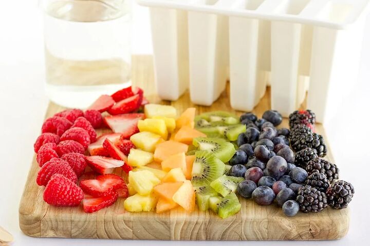 rainbow fruit popsicles, Fresh fruit on a cutting board lined up in rainbow color order