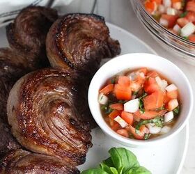 Tomato and Onion Salad in a bowl next to Picanha skewered steaks