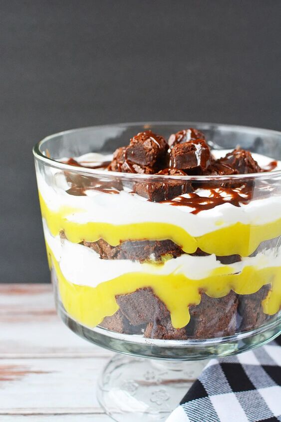Layers of brownies pudding and whipped cream in a trifle dish