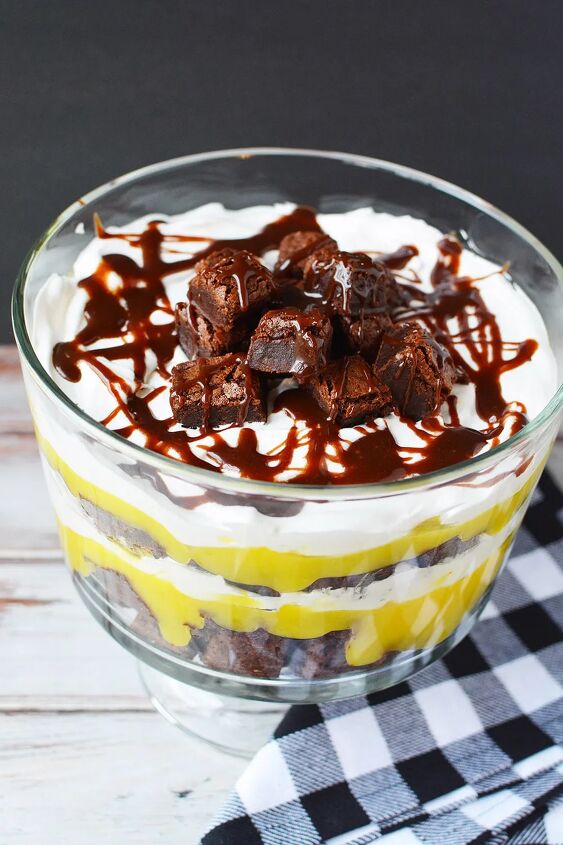 Brownie trifle on a table with a blue checked napkin