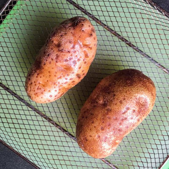 air fryer twice baked loaded potatoes, Oiled and salted potatoes on the fry basket ready to go in the air fryer