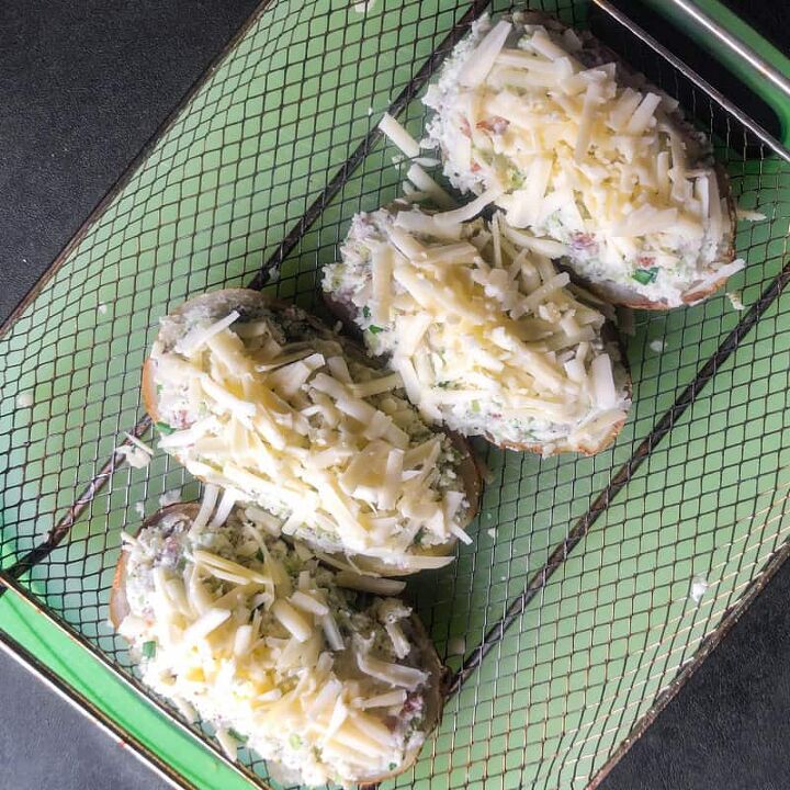 air fryer twice baked loaded potatoes, Potatoes topped with shredded cheese ready to go in the air fryer