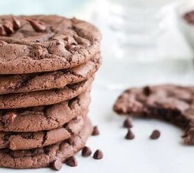 chewy brownie mix cookies recipe, A stack of brownie cookies with a cookie missing a bite next to chocolate chips on a white table