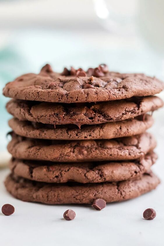 chewy brownie mix cookies recipe, Stack of brownie cookies with chocolate chips on a white table with a blue napkin