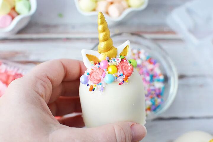 adorable unicorn hot chocolate bombs, Unicorn hot chocolate bomb with a gold horn and sprinkle mane