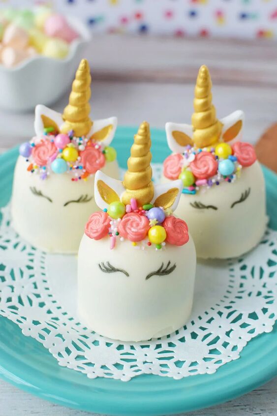 adorable unicorn hot chocolate bombs, Three white unicorn hot chocolate bombs with faces horns ears and manes