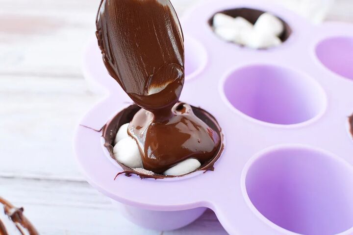 easy hot chocolate bombs, Putting melted chocolate over marshmallows in candy mold