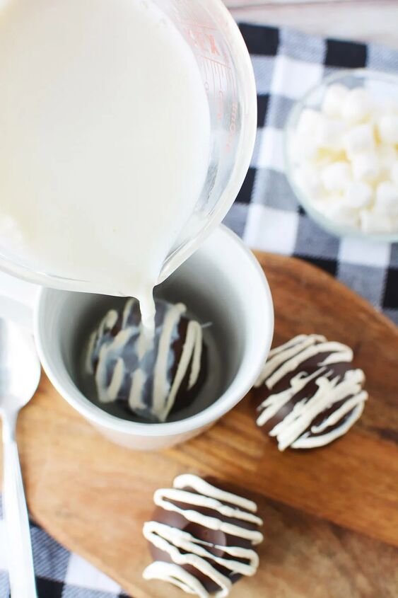 easy hot chocolate bombs, Pouring hot milk onto a hot cocoa bomb in a mug