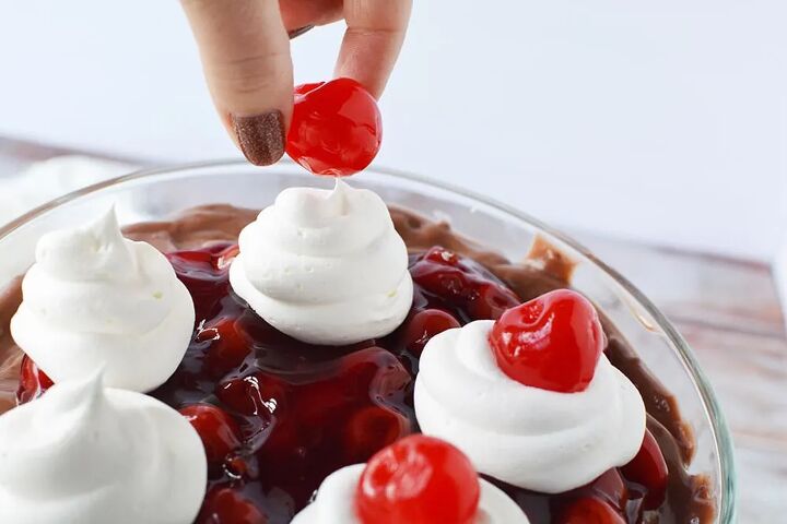 chocolate cherry black forest trifle, Placing cherries on whipped cream on top of a black forest trifle